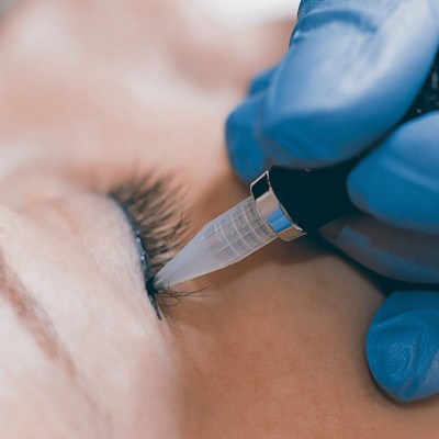 Permanent make up. Cosmetologist applying permanent makeup on ey Permanent make up. Cosmetologist applying permanent makeup on ey